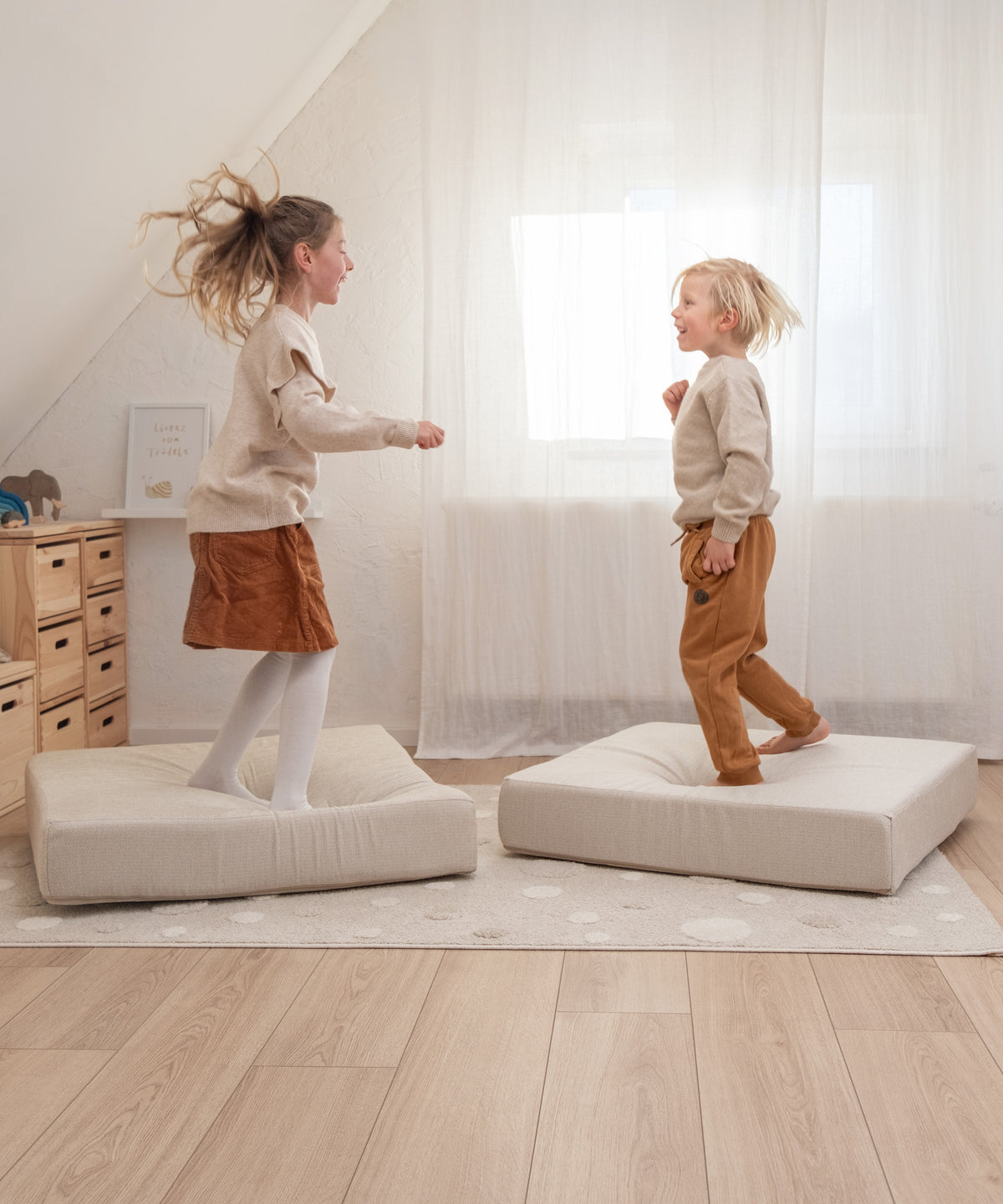  Kinder springen auf Hüpfpolster quadratisch in Rosé.